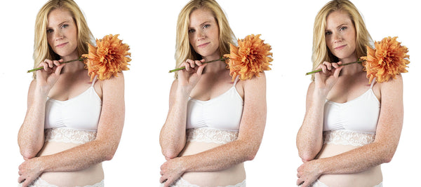 A woman holding a flower while wearing the white Astrid Bralette with lace, showcasing its delicate design and soft, wire-free support.
