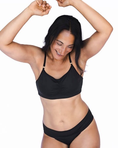 Woman wearing a black bikini on a white background