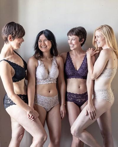 Four women wearing various lingerie styles against a plain background